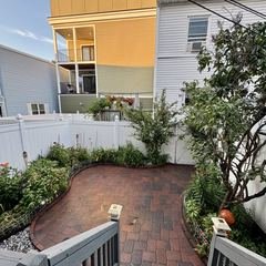 Backyard paver patio with planting beds around it
