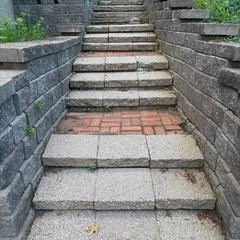 Granite steps rising between block retaining walls