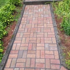 Red brick walkway with a soldier course border