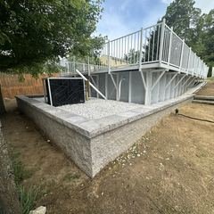 Poured retaining wall supporting an above ground pool deck